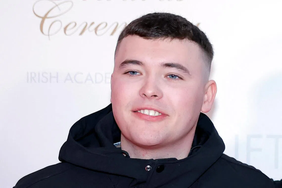 FILE PHOTO: Member of Kneecap Liam O'Hanna also known as Liam Og O hAnnaidh, who performs under the name of Mo Chara, poses on the red carpet at the Irish Film and Television Academy (IFTA) Awards in Dublin, Ireland, February 14, 2025. REUTERS/Clodagh Kilcoyne/File Photo