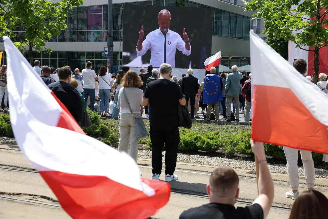 Polish Prime Minister Donald Tusk (on screen) hopes to galvanise support for his candidate, the liberal Warsaw mayor Rafal Trzaskowski.