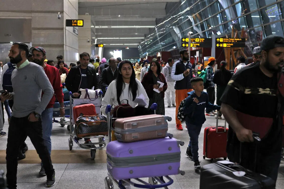 Travellers push carts with their luggage at the departure area of Terminal 3 at Indira Gandhi International Airport in New Delhi, India, December 14, 2022. REUTERS/Anushree Fadnavis
