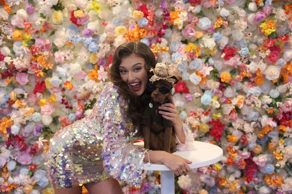 Model Rachel Pizzolato posing with a dog during The Pet Gala at GH on the Park in New York City on May 19, 2025. The Pet Gala by Anthony Rubio designs recreates outfits from the Met Gala for pets. 