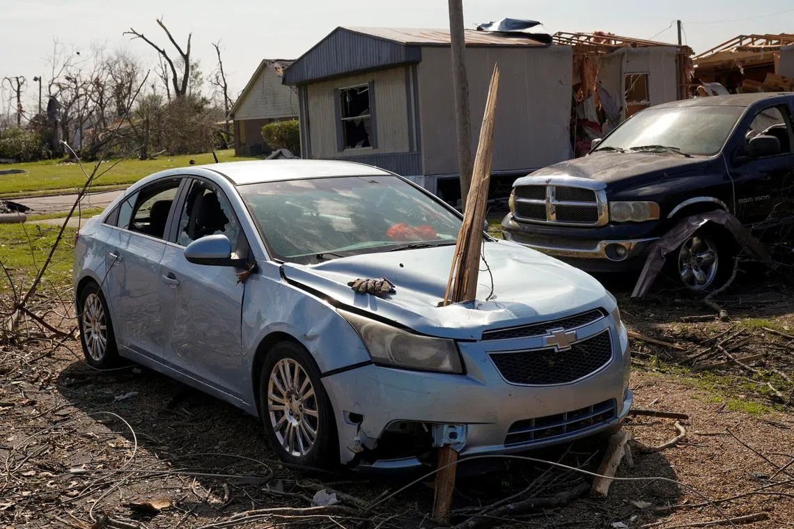 A vehicle is seen impaired by a piece of wood after thunderstorms spawning high straight-line winds and tornadoes ripped across the state, in Rolling Fork, Mississippi, U.S. March 26.