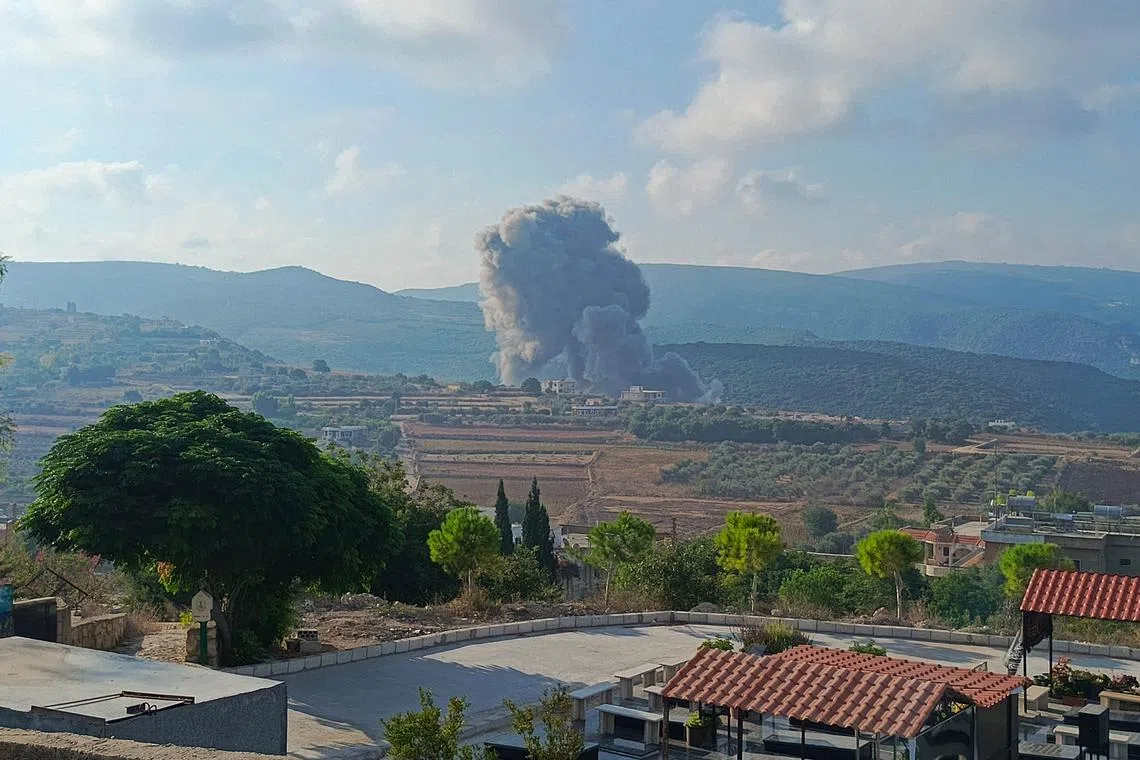 Smoke billows from the site of an Israeli airstrike on Zibqin in southern Lebanon on Aug 25, 2024, amid escalations in the ongoing cross-border tensions as fighting continues between Israel and Hamas militants in the Gaza Strip.