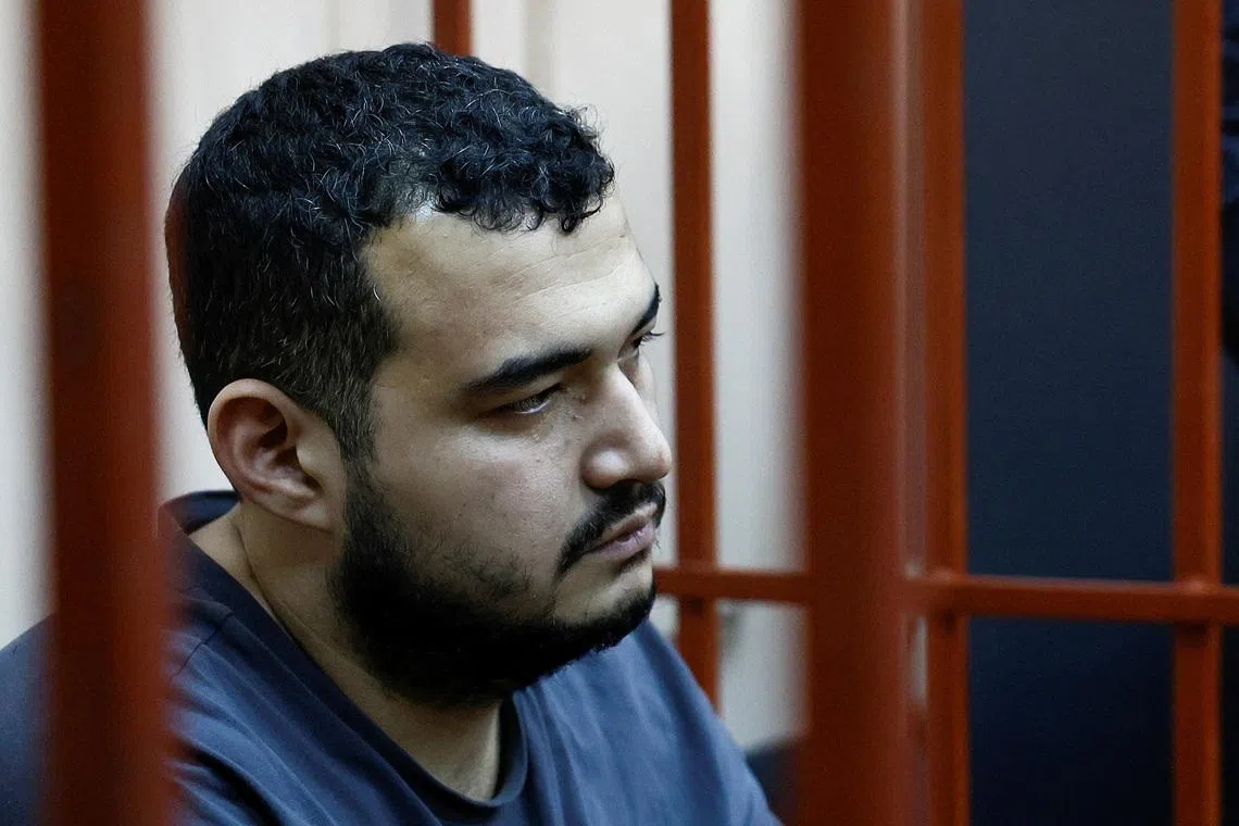 A detainee, named as Uzbek national Akhmad Kurbanov and considered by investigators as a suspect in the murder of chief of Russia's Nuclear, Biological and Chemical Protection Troops Igor Kirillov along with his assistant, sits inside an enclosure for defendants as he attends a court hearing in Moscow, Russia December 19, 2024. REUTERS/Yulia Morozova