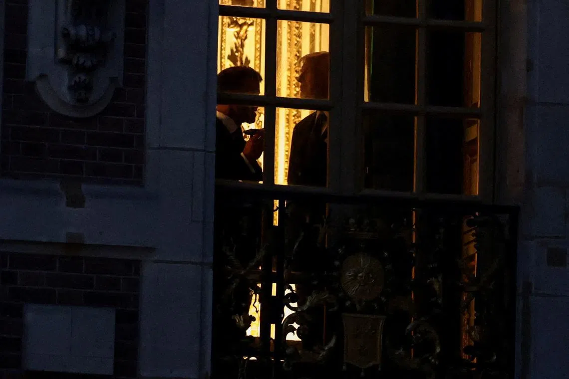 French President Emmanuel Macron and US President Donald Trump are silhouetted behind a window, ahead of a dinner commemorating the 250th anniversary of the United States' independence, at the Palace of Versailles, near Paris, France, June 17, 2026. 