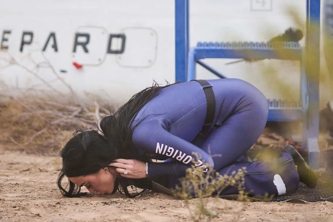 US singer Katy Perry kissing the ground upon returning to Earth after a flight on Blue Origin New Shepard NS-31, which brought the passengers beyond the Karman line - the internationally recognized boundary of space - in Van Horn, West Texas, April 14, 2025. Five other women were on the flight. 