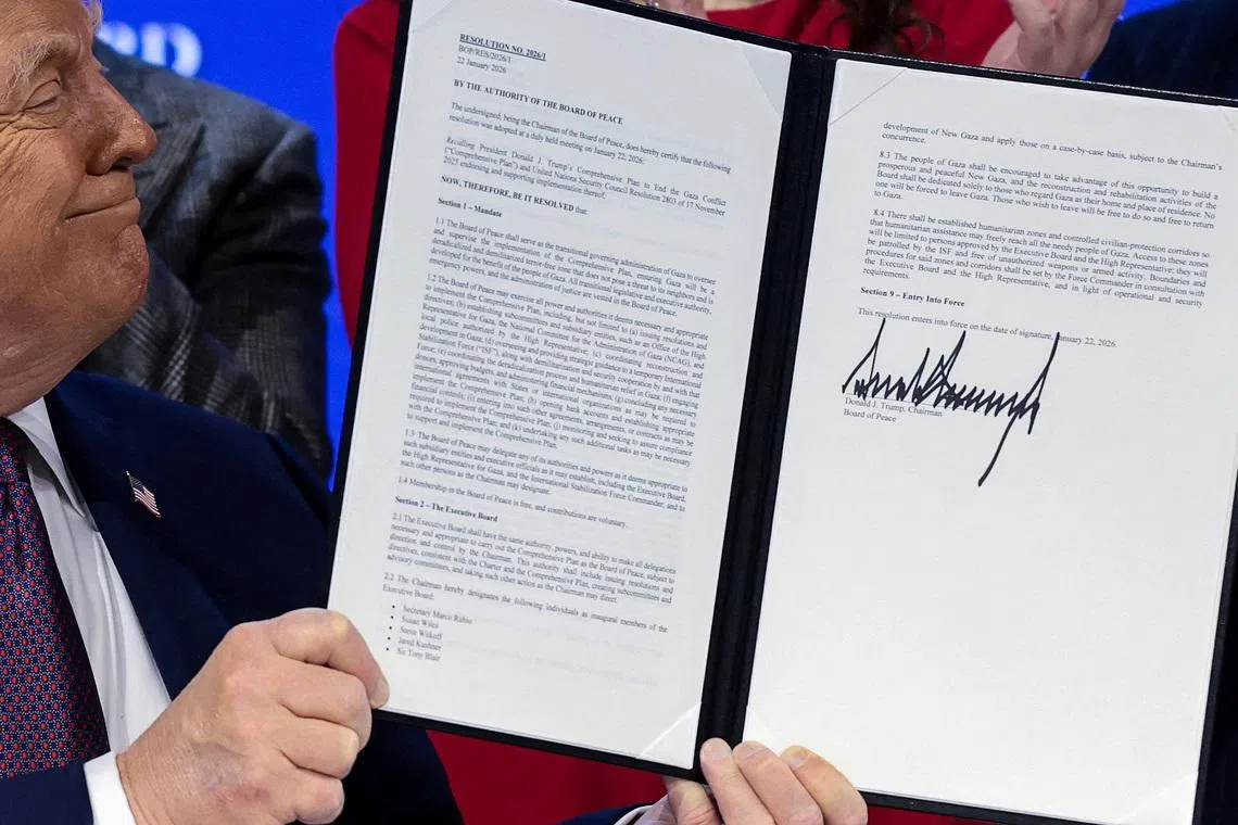 FILE PHOTO: U.S. President Donald Trump holds a signed resolution, as he attends a charter announcement for his Board of Peace initiative aimed at resolving global conflicts, alongside the 56th annual World Economic Forum (WEF), in Davos, Switzerland, January 22, 2026. REUTERS/Jonathan Ernst/File Photo