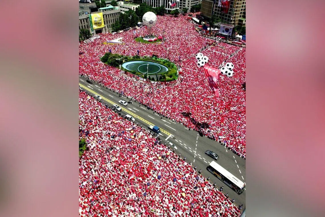Football fans fill the streets of central Seoul on June 29, 2002, during the FIFA World Cup co-hosted by South Korea and Japan.