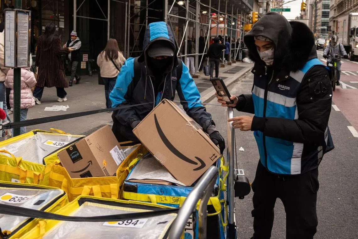 Workers delivering Amazon packages on Black Friday in New York. US shoppers spent US$10.8 billion (S$14.4 billion) buying their Black Friday bargains online. 