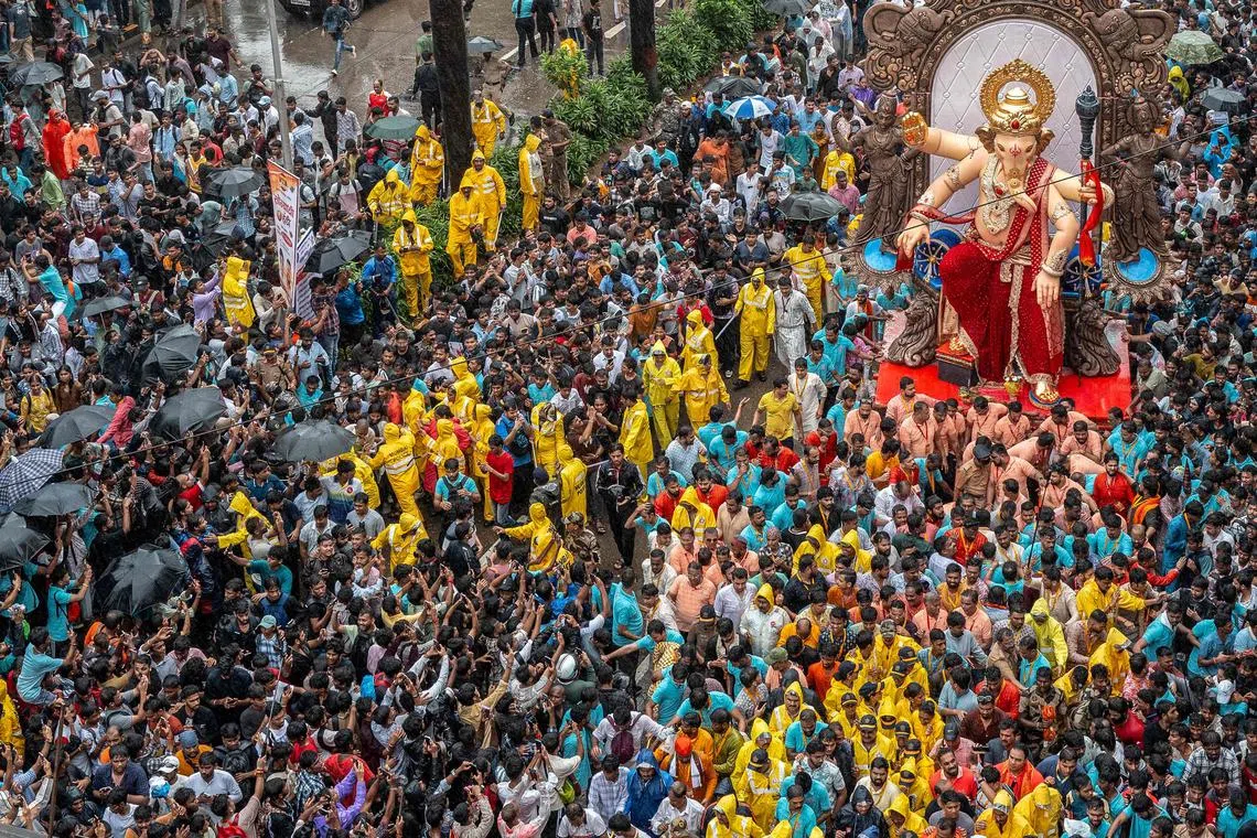 Devotees carrying an idol of the elephant-headed Hindu deity 'Ganesha' during a procession in Mumbai, India on August 17, 2025, ahead of the Ganesh Chaturthi festival. 