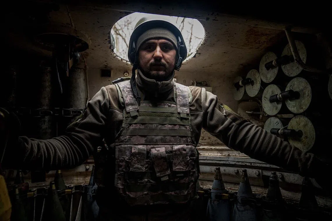 A Ukrainian artilleryman from the 24th brigade stands inside of a 2S1 Gvozdika self-propelled howitzer at a position along the front line in the vicinity of Bakhmut, Donetsk region, on Dec 10, 2022 amid the Russian invasion of Ukraine. 