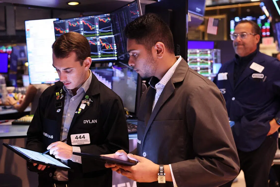 Traders working on the floor of the New York Stock Exchange, in New York City, during morning trading on Aug 6. 