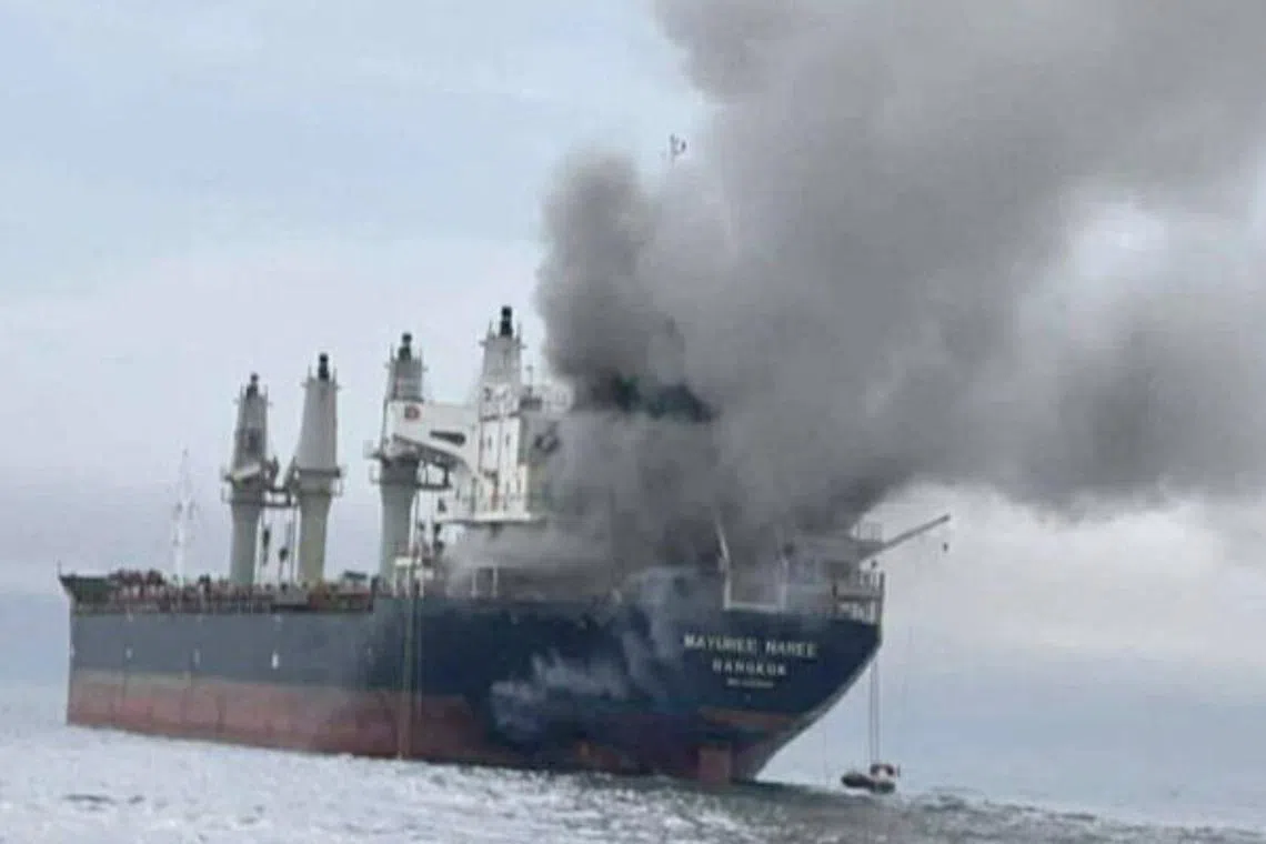 Thailand-flagged cargo ship Mayuree Naree engulfed in black smoke after being hit in the Strait of Hormuz in March. 