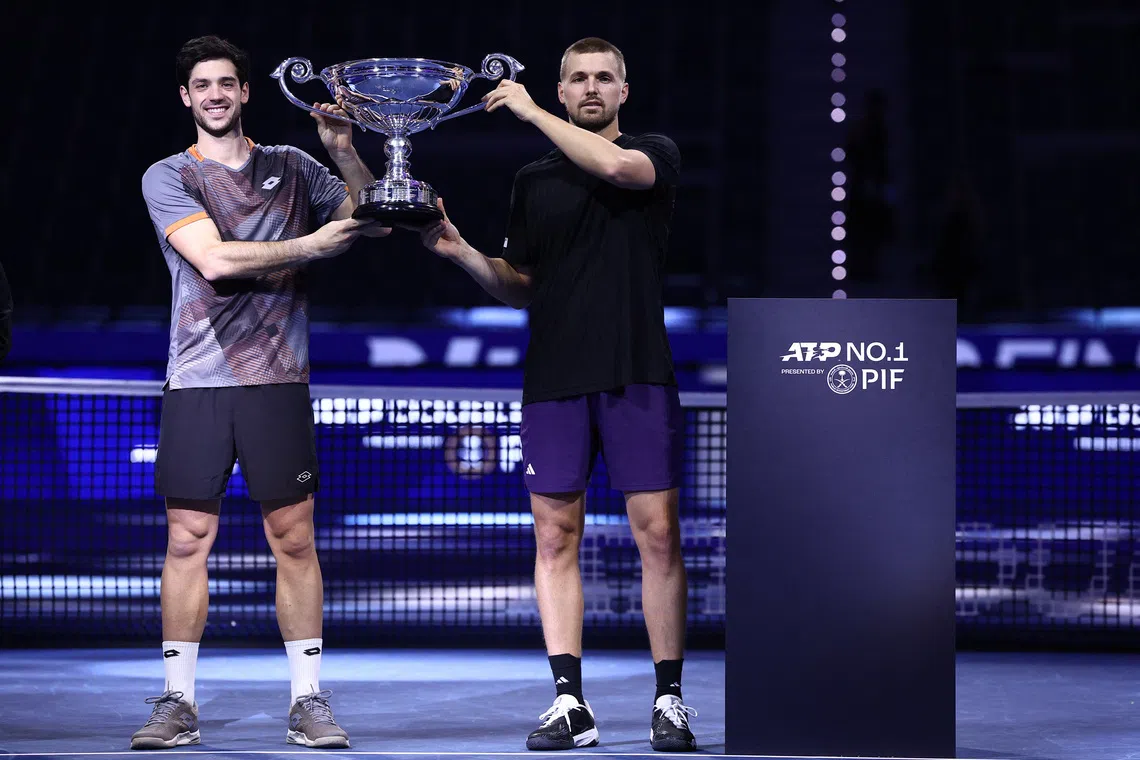 Tennis - ATP Finals - Turin - Palasport Olimpico, Turin, Italy - November 11, 2025 Britain's Julian Cash and Lloyd Glasspool pose with the ATP Doubles of the Year trophy REUTERS/Guglielmo Mangiapane