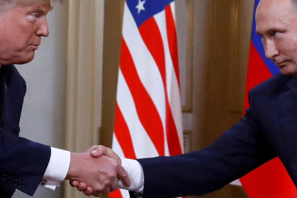 FILE PHOTO: U.S. President Donald Trump and Russia's President Vladimir Putin shake hands as they meet in Helsinki, Finland July 16, 2018. REUTERS/Kevin Lamarque/File Photo