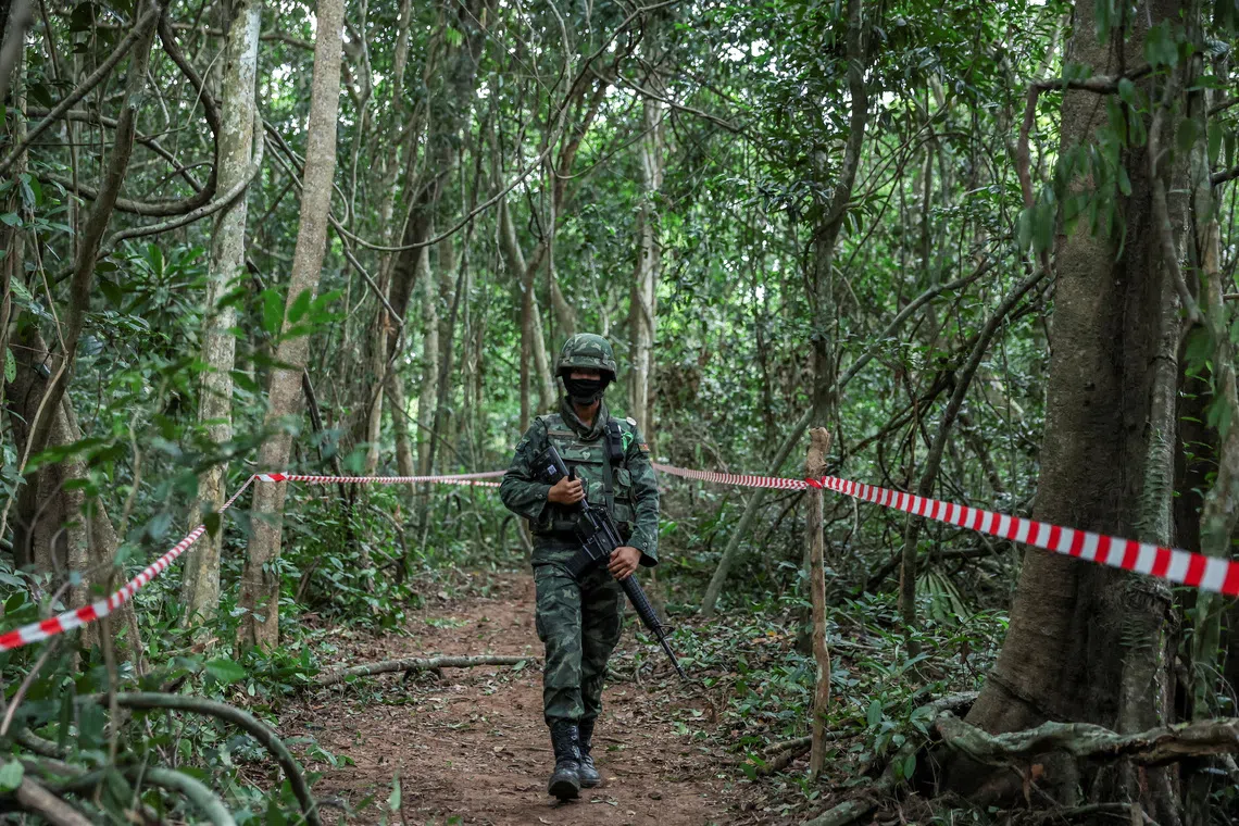 FILE PHOTO: Person from Thai military walks near Thai-Cambodian border at Chong Chub Ta Mok area, where landmines were found deployed, following a ceasefire between Cambodia and Thailand, in Surin Province, Thailand, August 20, 2025. REUTERS/Chalinee Thirasupa/File Photo