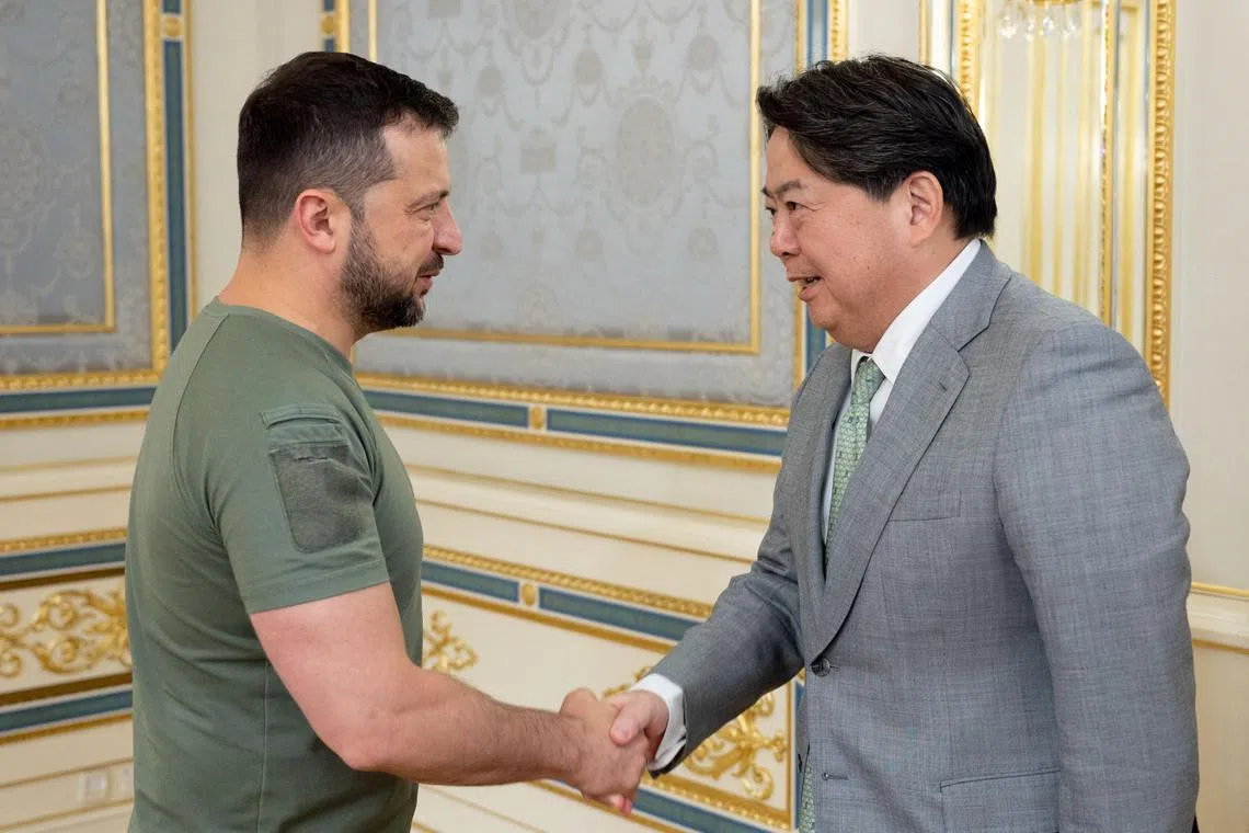 Ukraine's President Volodymyr Zelensky (left) welcomes Japanese Foreign Minister Yoshimasa Hayashi to Kyiv.