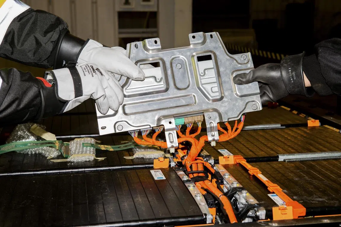 Employees disassembling a Ford electric car battery at Redwood Materials in Carson City, Nevada, on March 2, 2022. 
