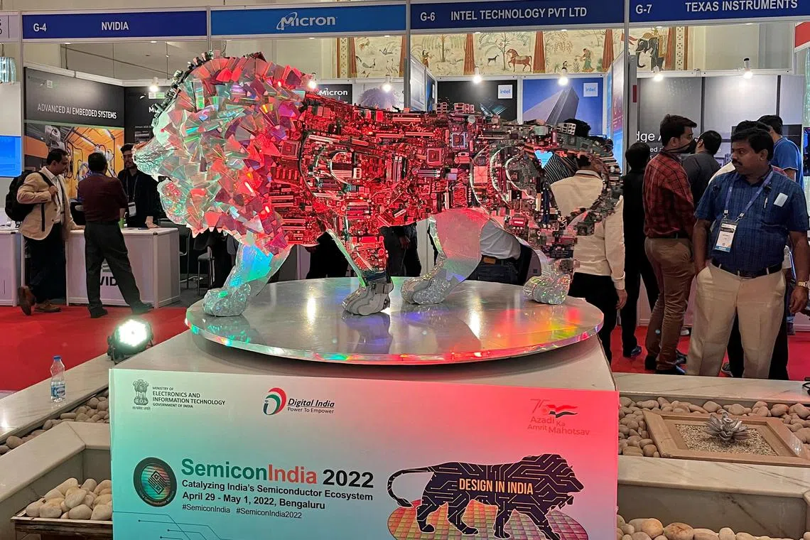 FILE PHOTO: Visitors stand next to a "Make In India" logo during a three-day semiconductor event in Bengaluru, India, April 30, 2022. REUTERS/Munsif Vengattil/File Photo