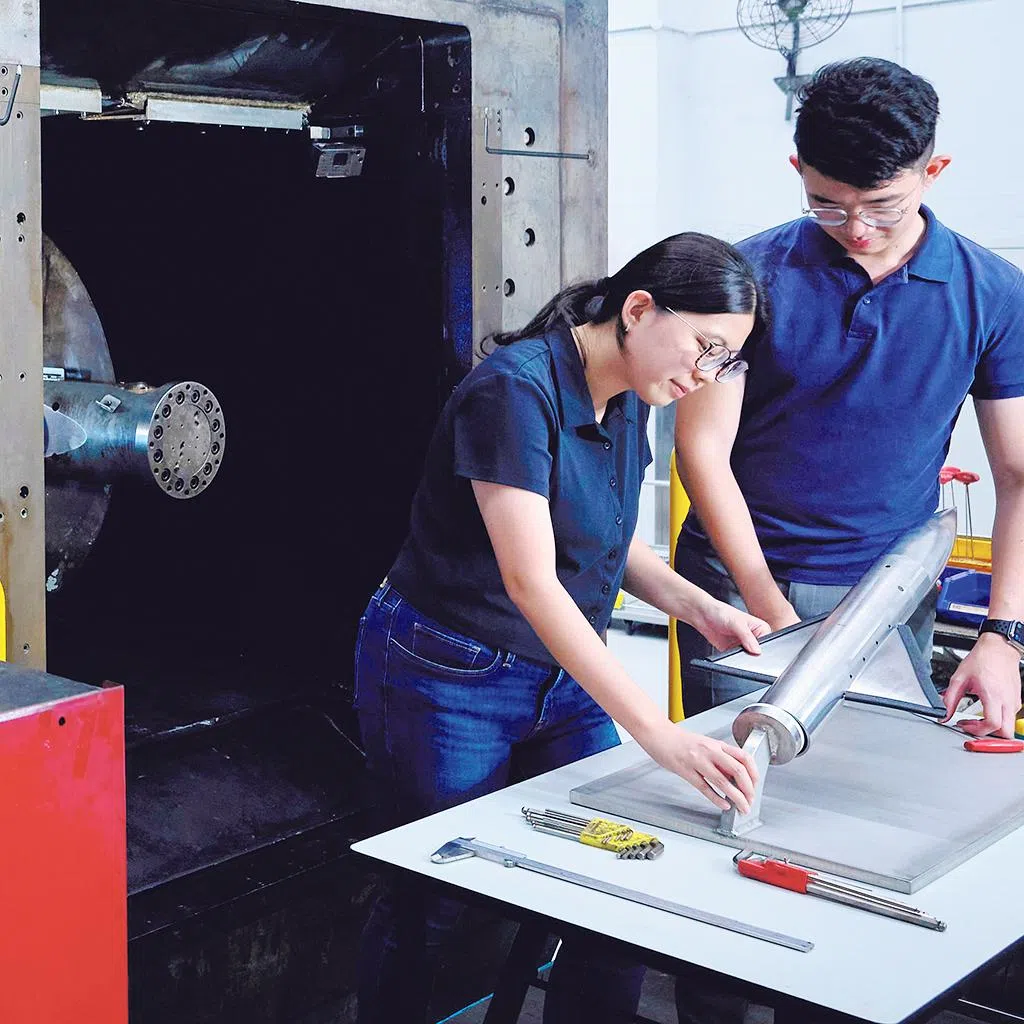 singapore best employers 2026 dso national laboratories engineer jolene kwek (left) preparing for an aerodynamics test, highlighting the hands-on work central to her on-the-job learning