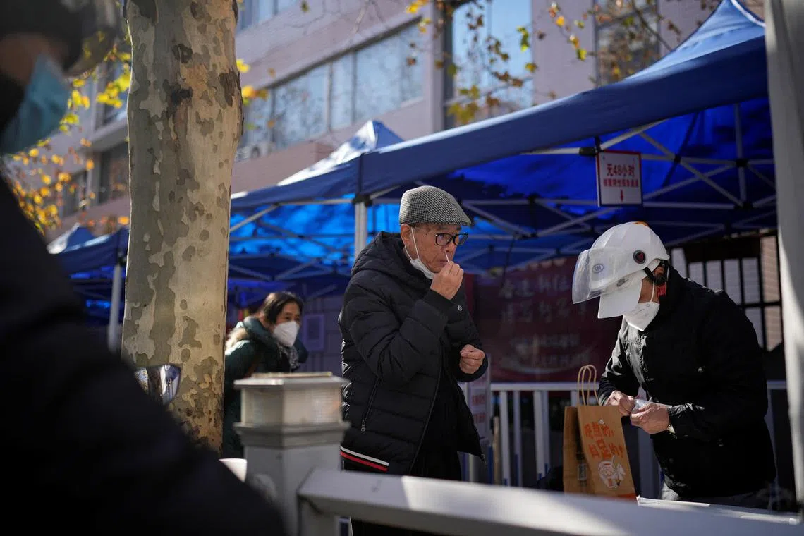 A man takes a rapid antigen test for Covid-19 at an entrance of a hospital in Shanghai, China.