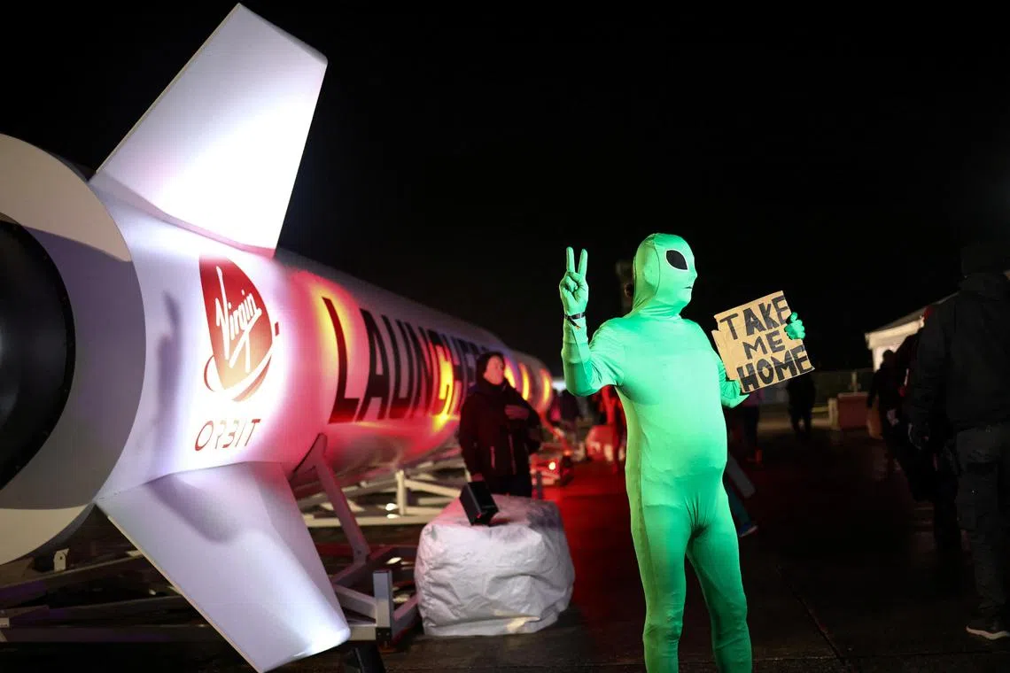 A person wearing an alien costume poses for a photographer during a spectator event for Virgin Orbit's LauncherOne first UK launch from Spaceport Cornwall at Cornwall Airport Newquay in Newquay, Britain, January 9, 2023. REUTERS/Henry Nicholls
