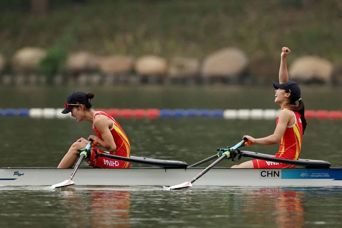 Asian Games - Hangzhou 2022 - Rowing - Fuyang Water Sports Centre, Hangzhou, China - September 24, 2023 China's Jiaqi Zou and Xiuping Qiu celebrate after winning gold after the Lightweight Women's Double Sculls REUTERS/Ann Wang