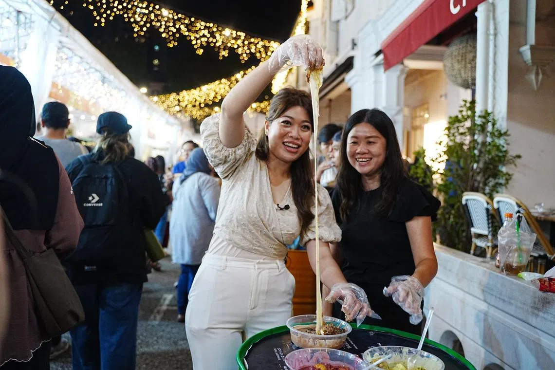 Berita Harian journalist Dahlia Zulkifli (left) and STFood Online Editor Eunice Quek ate their way through this year's Kampong Gelam Ramadan Bazaar.
