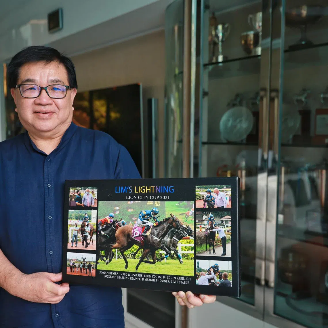 ST20230613_202395108223/jnhorse/Jean Iau/Jason Quah

Mr Lim Siah Mong, owner of Lim’s Stables, photographed with a photo of one of his horses, and some of his trophies, on June 13, 2023
//
Feature on the end of racing, speaking to horse racing owners on what the closure of Singapore Turf Club means to them