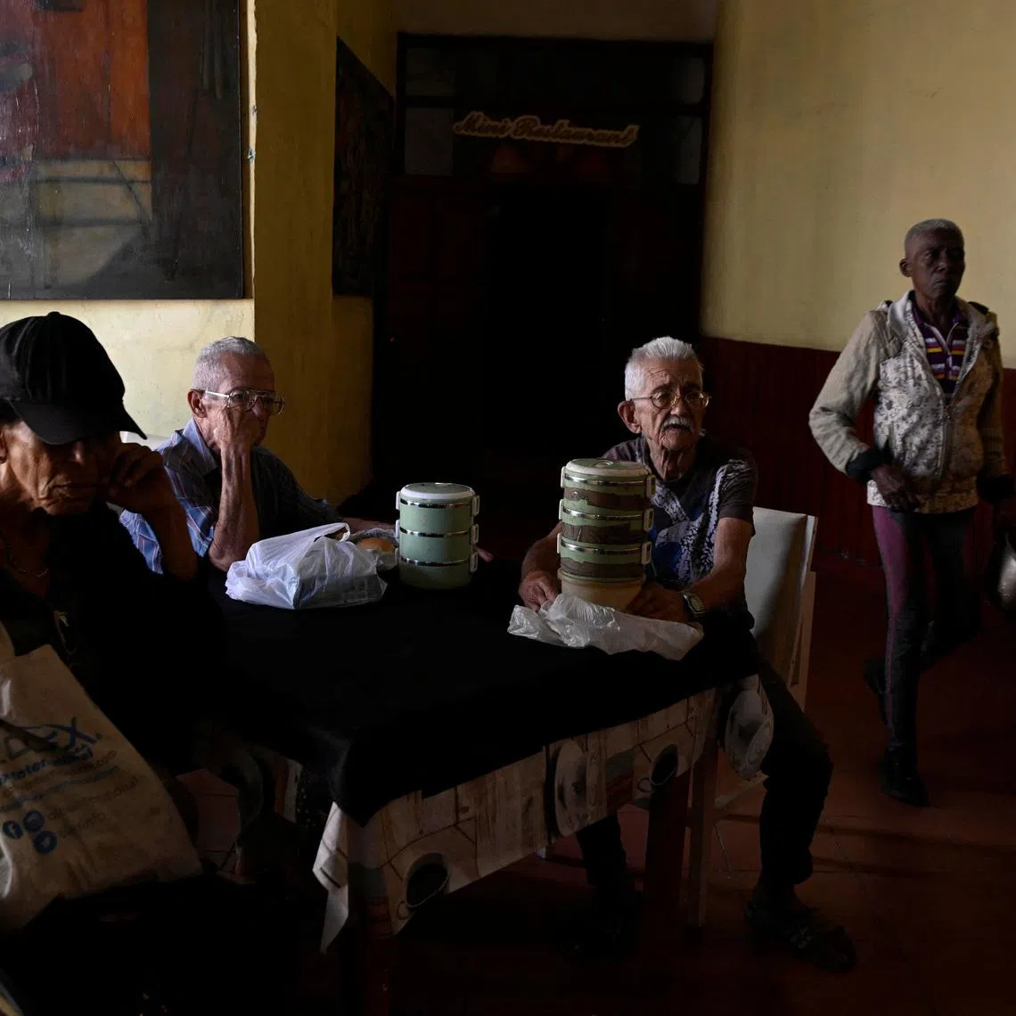 A group of elderly people wait at a dining hall to receive food assistance through the Sistema de Atencion a la Familia (SAF) system in Havana, Cuba, March 10, 2026. Pensions in Cuba have shrunk to the equivalent of $7 a month on the black-market exchange, as the peso has lost about a third of its value against the dollar since the start of the blockade. REUTERS/Norlys Perez