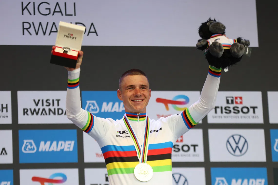 Cycling - Road World Championships 2025 - Kigali, Rwanda - September 21, 2025 Gold medallist, Belgium's Remco Evenepoel celebrates on the podium after winning the Men's Elite Individual Time Trial REUTERS/Jean Bizimana