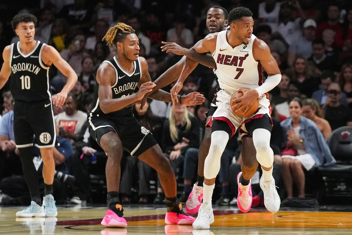 Miami Heat forward Giannis Antetokounmpo (in white) recorded 20 points, 15 rebounds and nine assists in just 23 minutes.