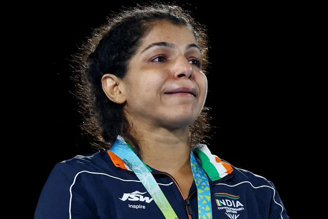 FILE PHOTO: Commonwealth Games - Wrestling - Women's Freestyle 62kg - Medal Ceremony - Coventry Arena, Coventry, Britain - August 5, 2022 Gold Medallist India's Sakshi Malik celebrates on the podium during the medal ceremony REUTERS/Hannah Mckay/File Photo