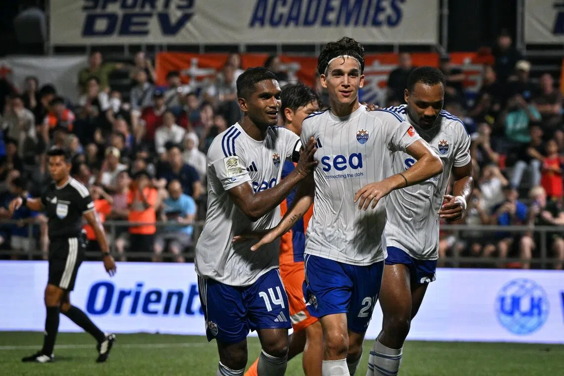 Lion City Sailors midfielder Giovanni Haag (centre) celebrating with Hariss Harun (left) and Matthias Phaeton after opening the scoring against FC Jurong with a penalty in the 41st minute.