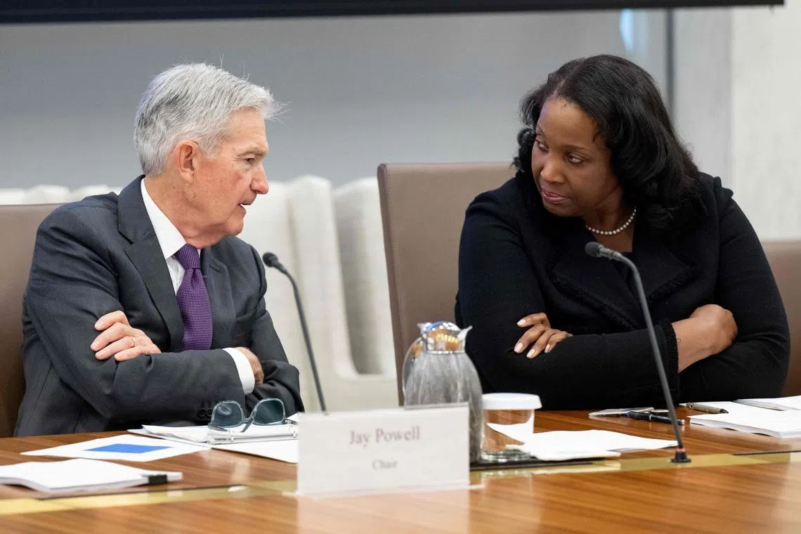 Chairman of the US Federal Reserve Jerome Powell (left) speaking with Lisa Cook, member of its Board of Governors, on June 25. Both are under pressure by US President Donald Trump to quit the central bank. 