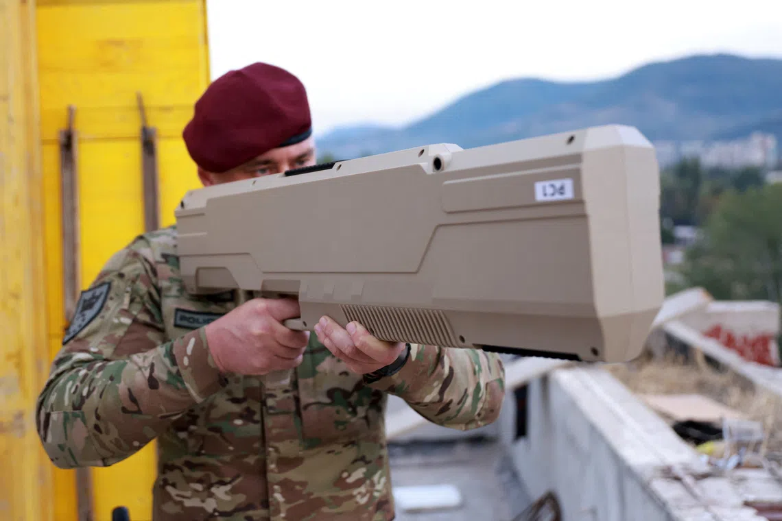 A member of the Special Police Unit of the Zenica-Doboj Canton Ministry of Interior (MUP ZDK) uses an anti-drone gun to disrupt drone signals and force drones to land, while securing the stadium ahead of the UEFA Nations League match between Bosnia and Poland in Zenica, Bosnia and Herzegovina, October 5, 2026. REUTERS/Dado Ruvic TPX IMAGES OF THE DAY