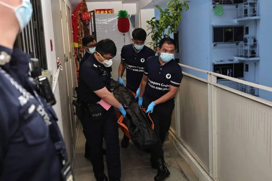 One of the bodies being removed from the unit at Block 408B Northshore Drive, at 7.18pm on Feb 27.
