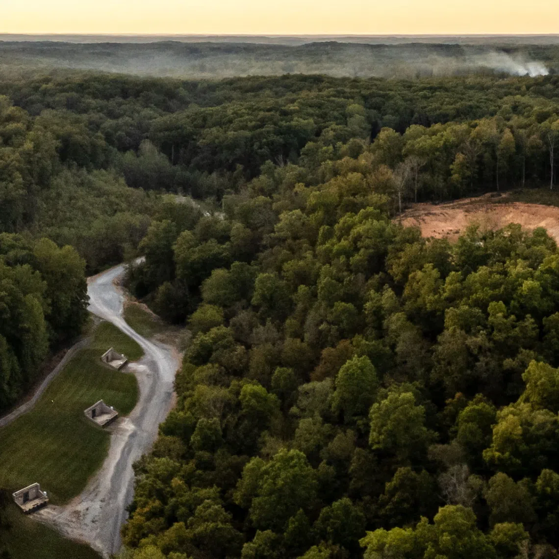 Smoke billows in the distance after an explosion at Accurate Energetic Systems in McEwen, Tennessee, on Oct 10.
