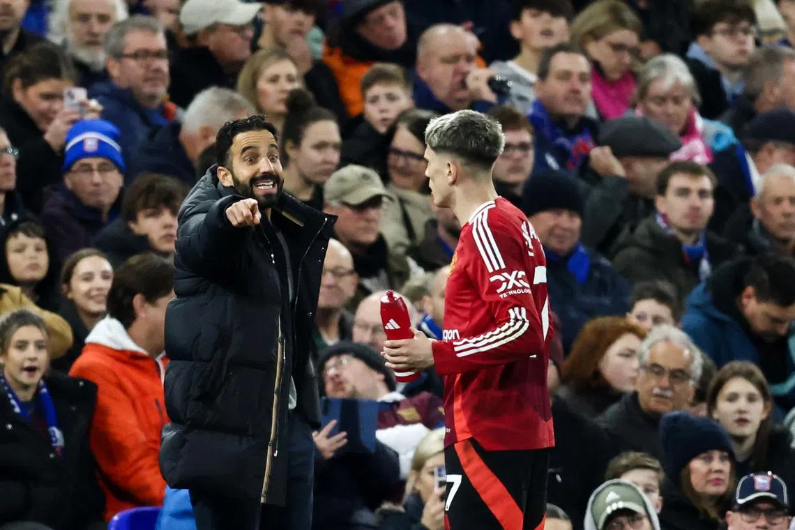 Manchester United's head coach Ruben Amorim (left) gives indications to Manchester United's Argentinian midfielder Alejandro Garnacho.