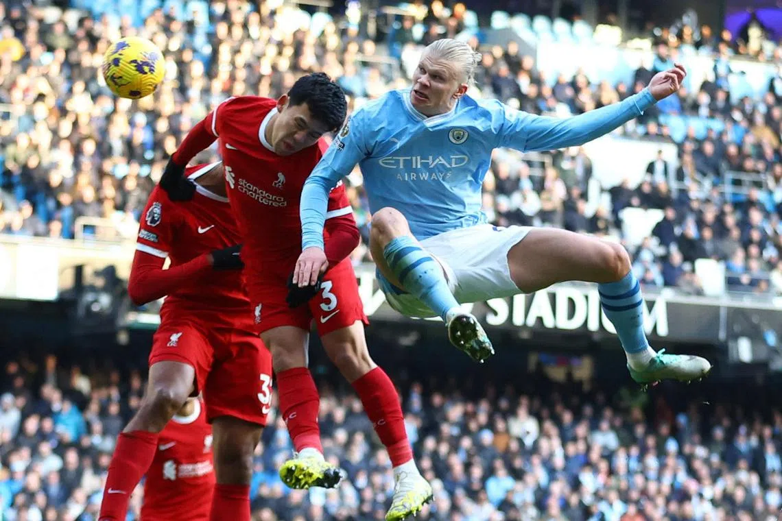 Manchester City's Erling Haaland in action with Liverpool's Wataru Endo.