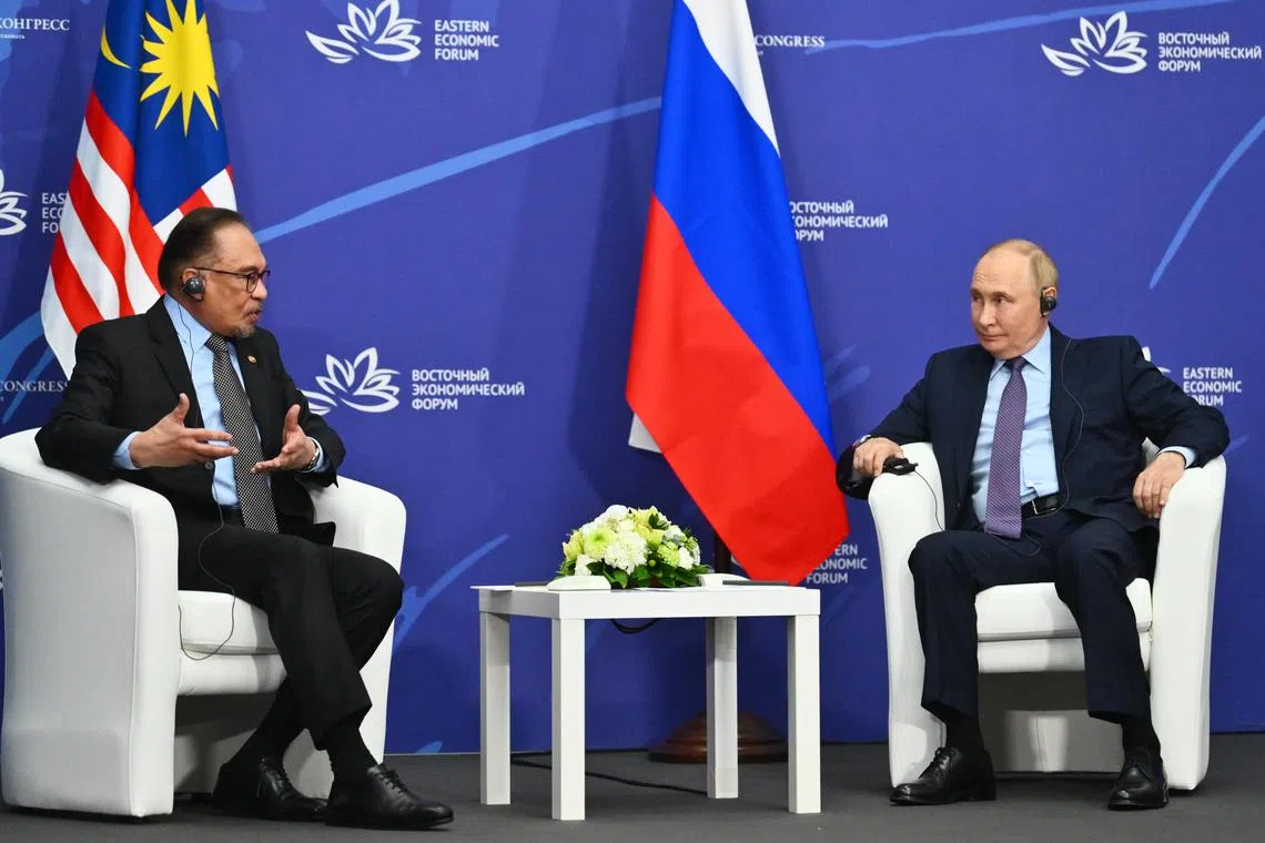 Russian President Vladimir Putin (right) and Mr Anwar attend a meeting on the sidelines of the Eastern Economic Forum.