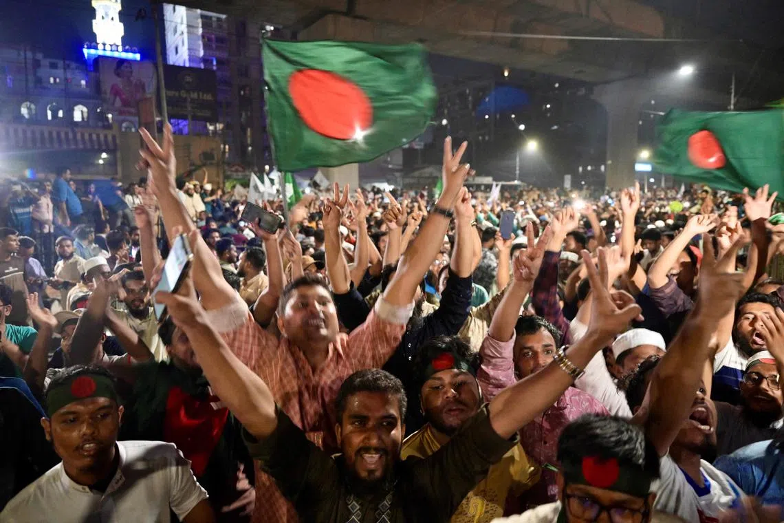 Bangladeshis celebrate after the government banned all activities of the Awami League.