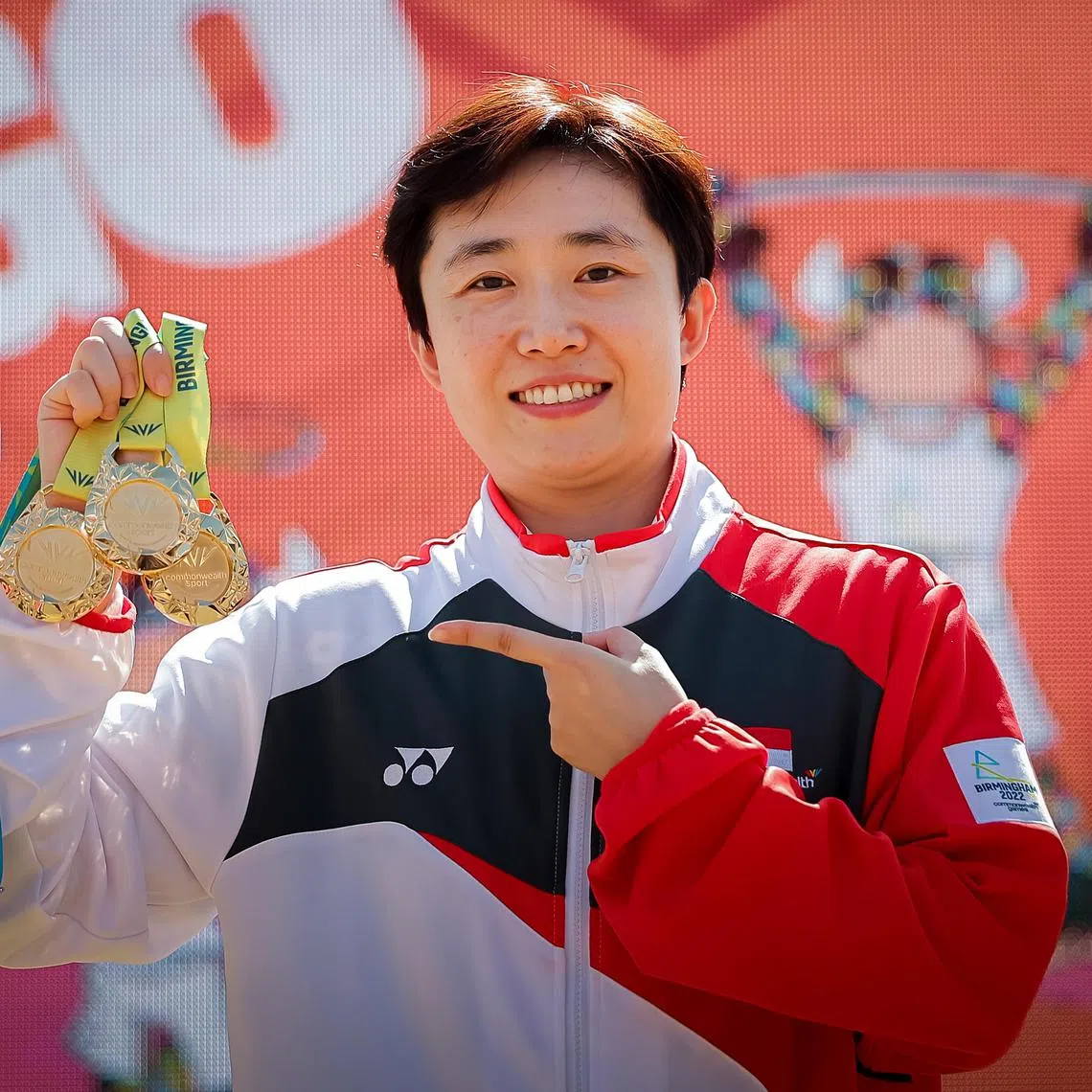 Singapore table tennis player Feng Tianwei posing with her medals at the Birmingham Commonwealth Games in 2022. 
