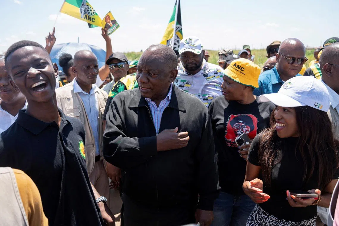 FILE PHOTO: South African president Cyril Ramaphosa interacts with youth during his door-to-door election campaign where he visited voting stations and homes encouraging citizens to register for the upcoming elections, in Soweto, South Africa, February 3, 2024. REUTERS/Ihsaan Haffejee/File Photo