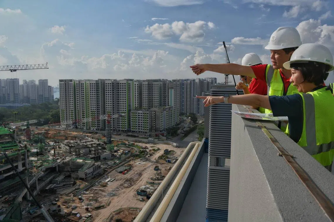 Education Minister Chan Chun Sing (second left) observing the progress of the new SIT campus at the Punggol Digital District on May 22, 2023.