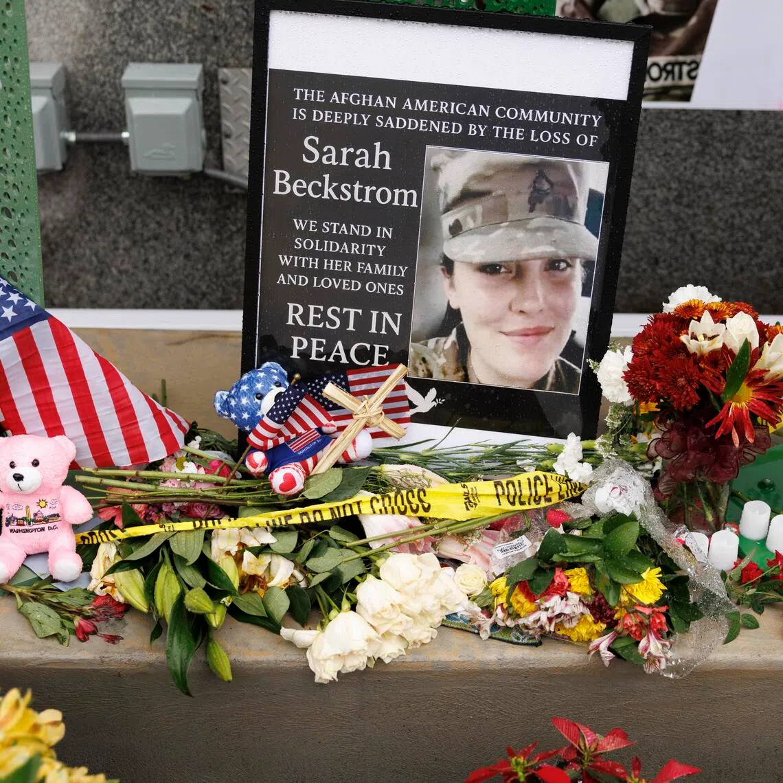 epa12565349 Tributes left at the scene where two National Guard members were shot, in Washington, DC, USA, 02 December 2025. Afghan national Rahmanullah Lakanwal has been charged with murder following the shooting of National Guard members Sarah Beckstrom and Andrew Wolfe on 25 November. US President Trump announced on 27 November that National Guard member Sarah Beckstrom died of her injuries following a shooting in Washington on 26 November, another National Guard member Andrew Wolfe remains in hospital.  EPA/WILL OLIVER