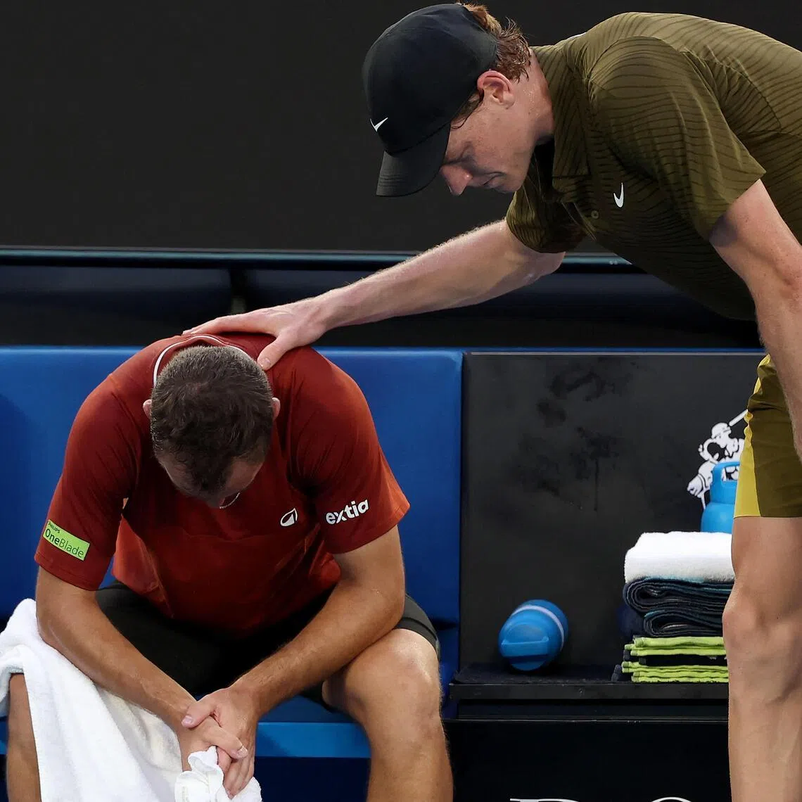 Italy’s Jannik Sinner consoles France’s Hugo Gaston as Gaston retires injured.