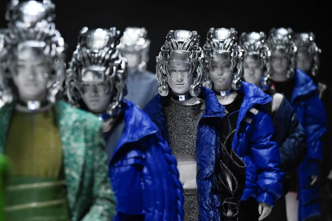 Models display a creation from the D. Martina Queen by Ding Jie during the China Fashion Week in Beijing on March 26.