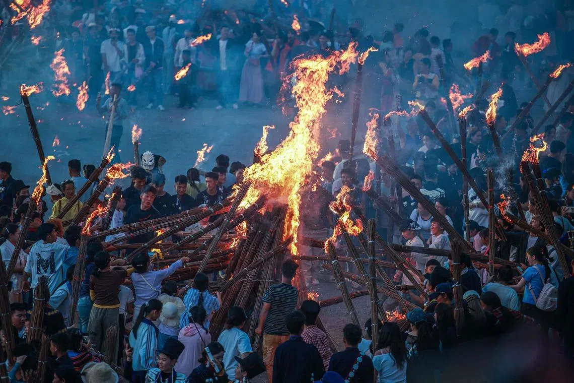 Participants burning torches as they celebrate the Torch Festival, held by the Yi ethnic minority, in Puge County, Liangshan Prefecture, in Chinas southwest Sichuan Province on July 19. 