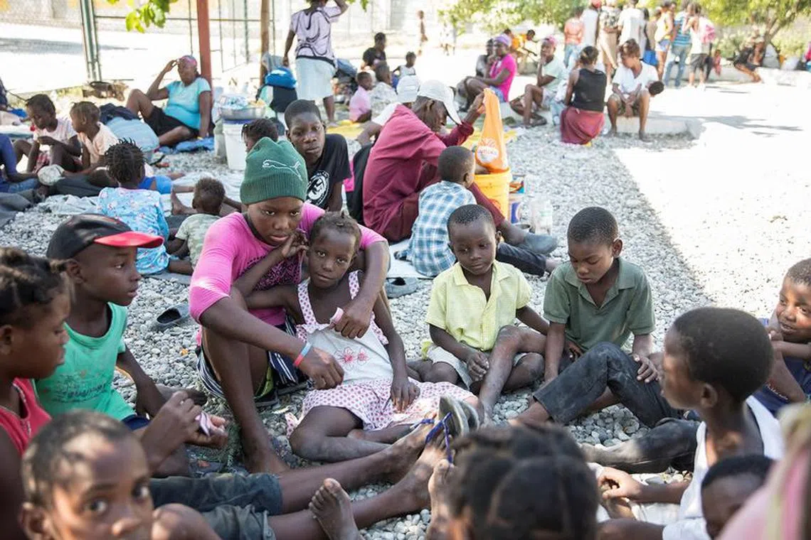 FILE PHOTO: People fleeing from violence after the murder of a local gang leader camp out in the courtyard of Cite Soleil's town hall, in Port-au-Prince, Haiti December 7, 2019. REUTERS/Valerie Baeriswyl/File Photo