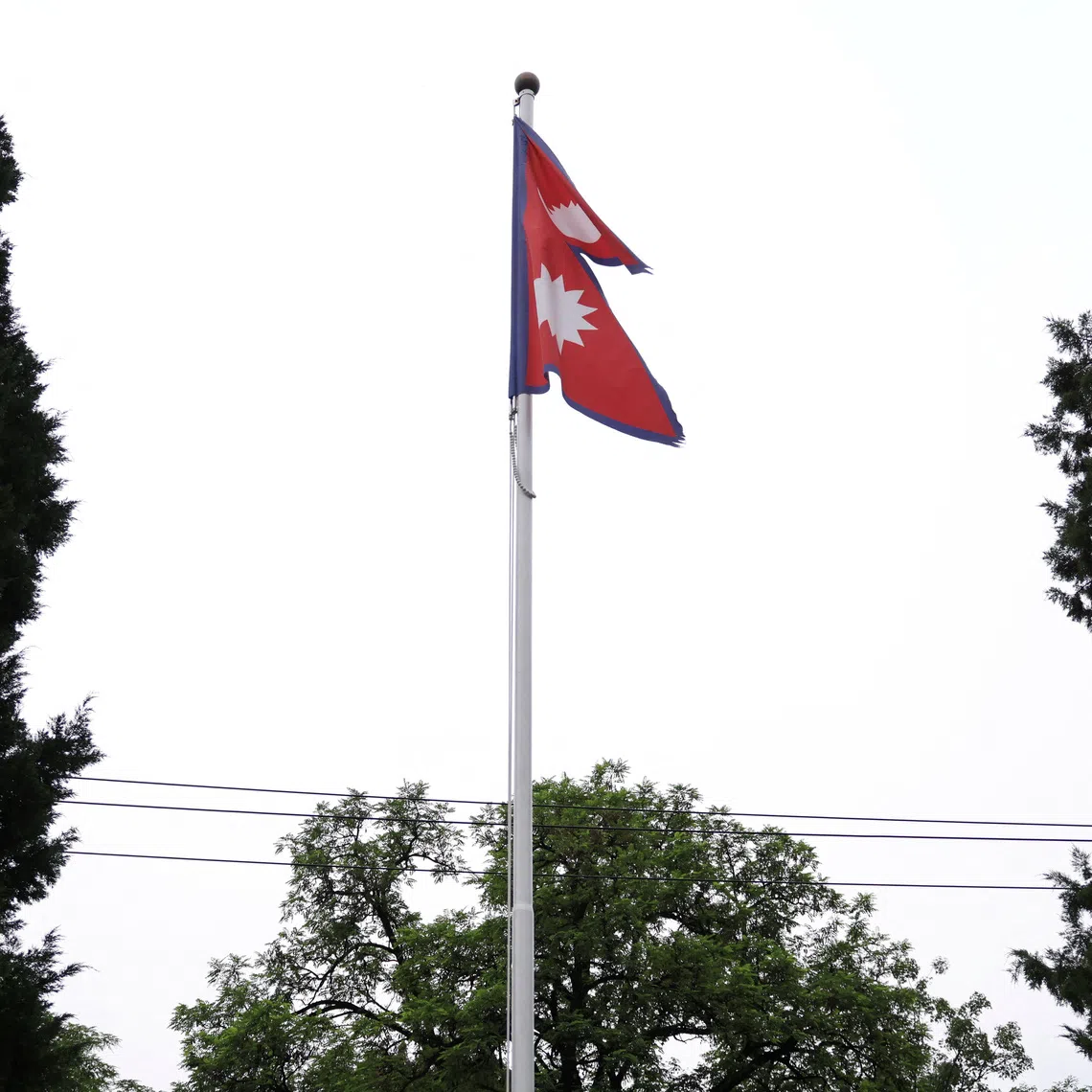 A national flag of Nepal flutters at the Embassy of Nepal in Beijing, China, June 16, 2026. REUTERS/Tingshu Wang